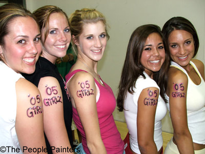 Girls wearing temporary tattoos for grad night party